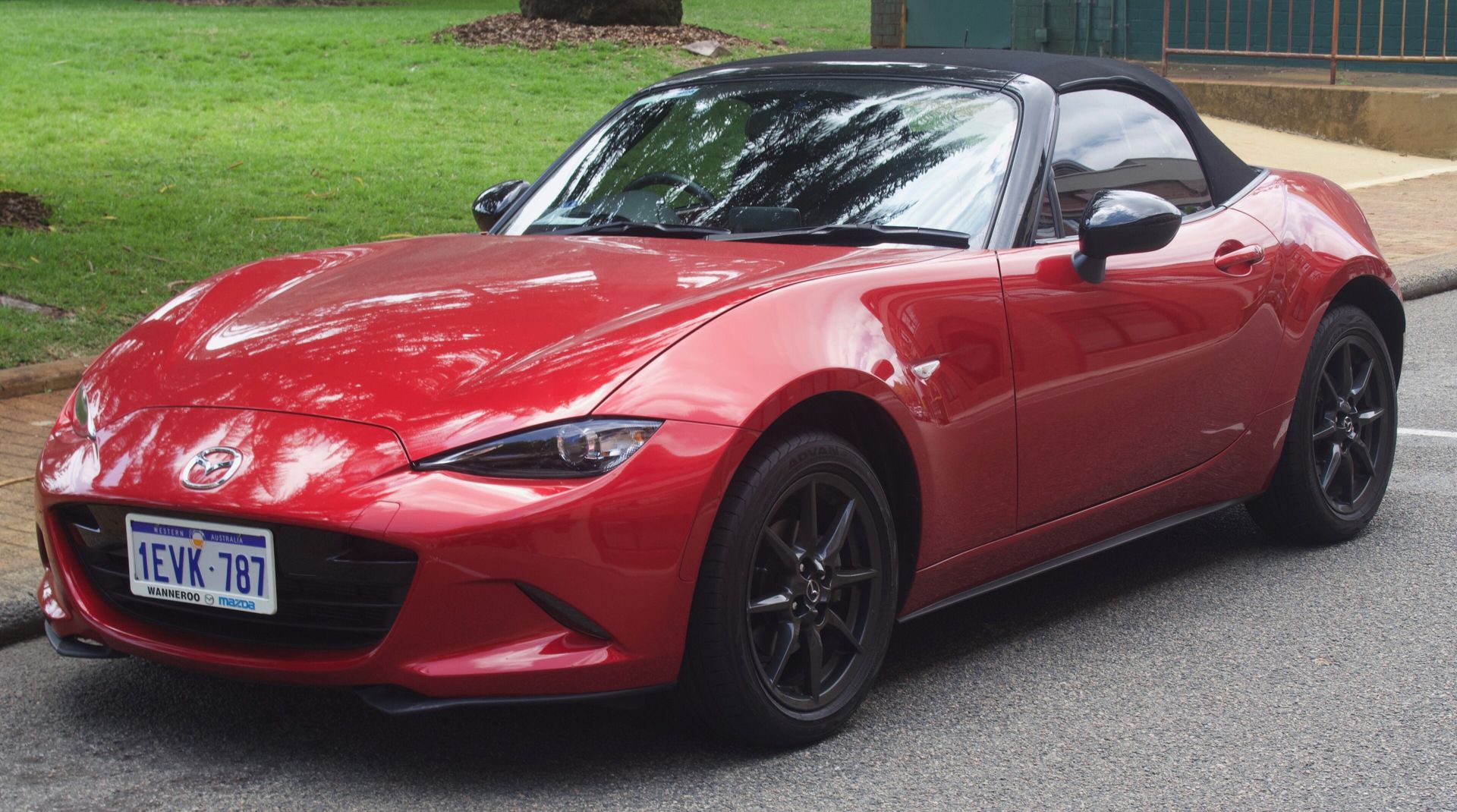 Mazda MX-5 Miata in Soul Red with the soft top up
